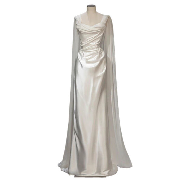 Elegant white evening gown featuring a draped bodice and flowing cape sleeves, perfect for formal events and weddings. The satin fabric enhances the gown's luxurious look and feel.