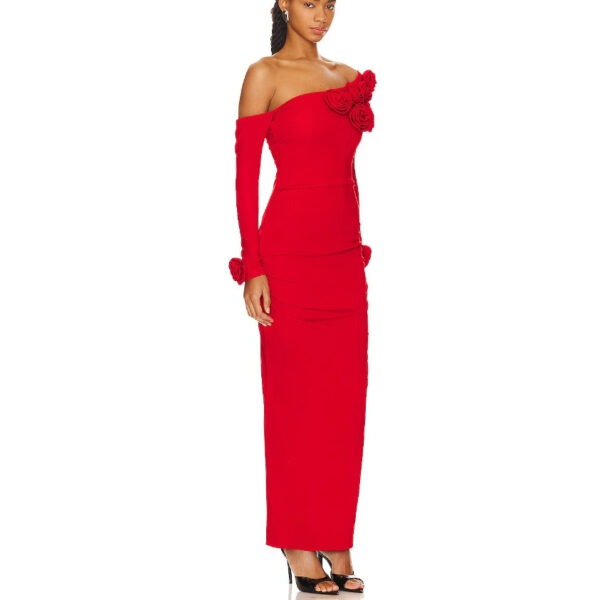 Elegant woman wearing a fitted red off-the-shoulder dress with floral accents, showcasing a sleek silhouette and long sleeves, perfect for formal occasions.