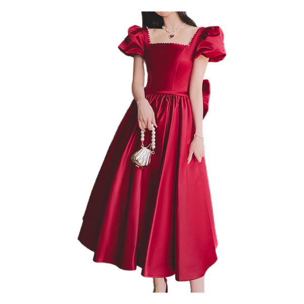 Elegant red satin dress with puff sleeves and a square neckline, styled with a matching bow at the back, perfect for formal events or special occasions.