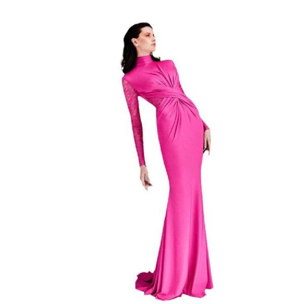 Elegant model in a striking pink evening gown with long lace sleeves and a twisted design, showcasing a sophisticated silhouette.