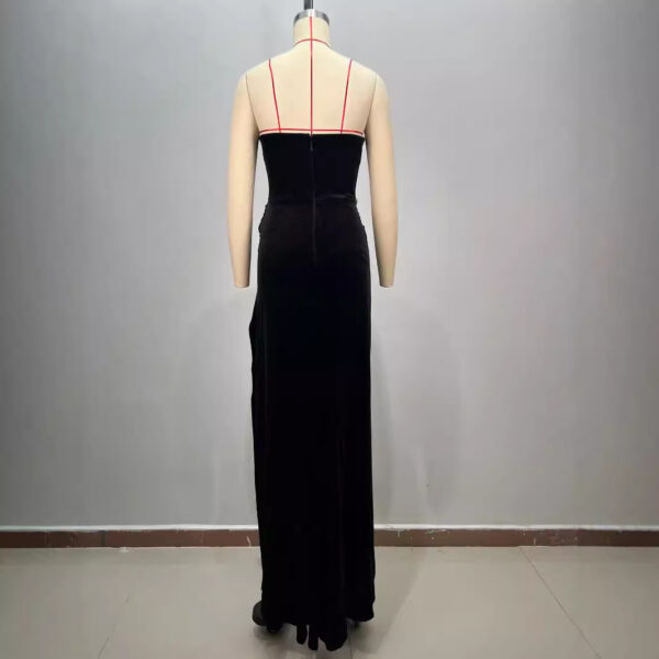 Back view of a black velvet evening gown with red spaghetti straps displayed on a mannequin, highlighting the sleek silhouette and elegant design. Ideal for formal occasions or special events.