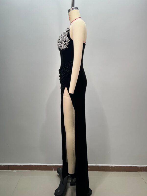 Elegant black evening gown displayed on a mannequin, featuring intricate floral beadwork on the bodice and a high slit on the side, showcasing a chic and sophisticated design ideal for formal occasions.